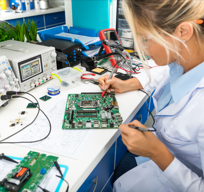 Female electronic engineer testing computer motherboard in laboratory